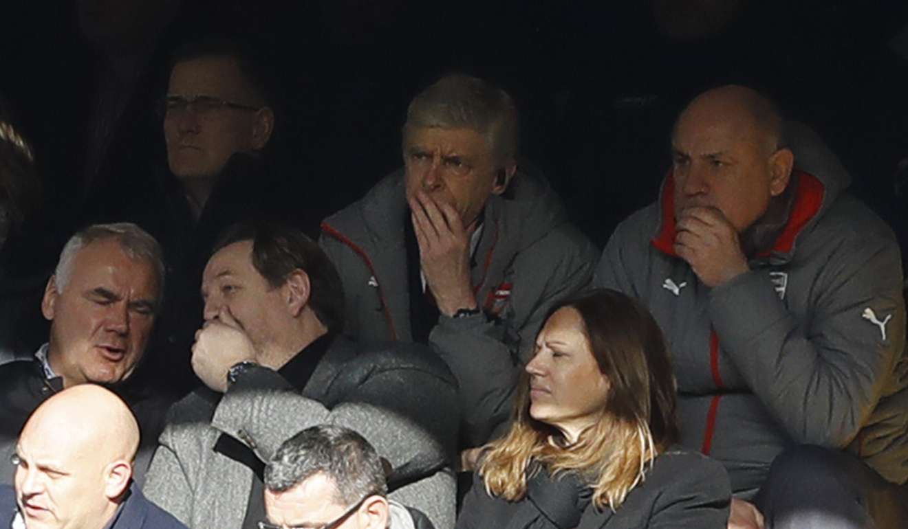 Arsenal manager Arsene Wenger sits in the stands due to a touchline ban. Photo: AP