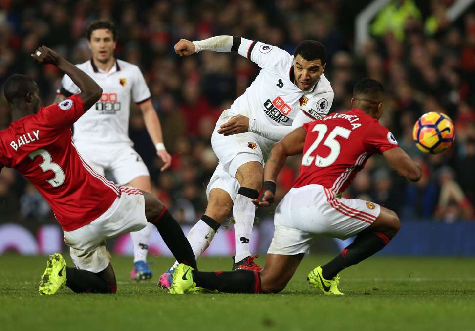 Watford’s Troy Deeney (centre) shoots at goal past Manchester United’s Eric Bailly and Anthonio Valencia. Photo: EPA