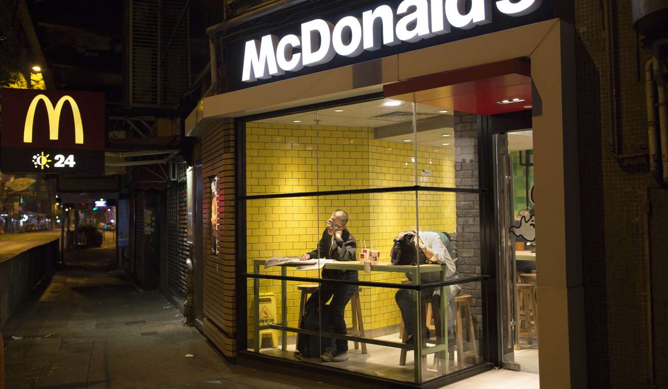 Two men sleep with their belongings at night in a 24-hour McDonald’s branch in Hong Kong. The recent death of a woman at a Hong Kong McDonald’s, where her body lay slumped at a table for hours unnoticed by other diners, has focused attention on the city’s “McRefugees” down and out people who spend their nights the fast food outlet’s 24-hour branches because they’ve nowhere anywhere else to go. Photo: AP