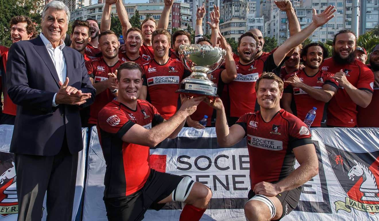 Valley co-captains Tom Broughton (left) and Matt Rosslee celebrate winning the league championship with their teammates. Photo: HKRU