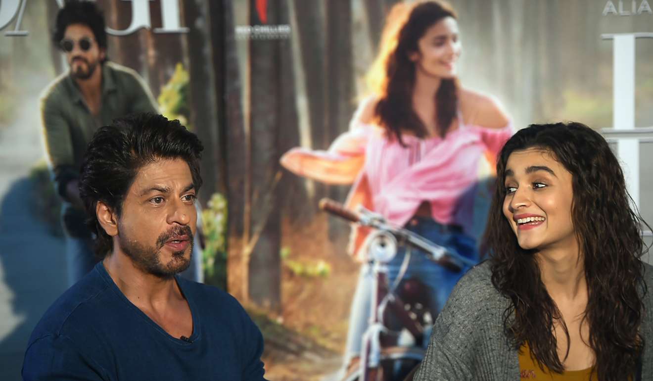 Bollywood actor Shah Rukh Khan, left, speaks as actress Alia Bhatt looks on in Mumbai.Photo: AFP