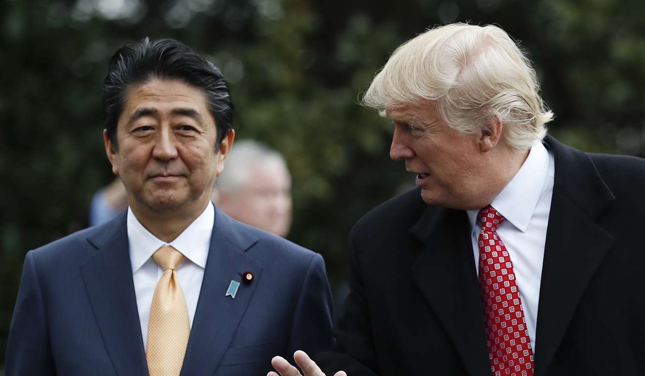US President Donald Trump talks to Japanese Prime Minister Shinzo Abe, left, as they pause before boarding Marine One on the South Lawn of the White House. File photo: AP