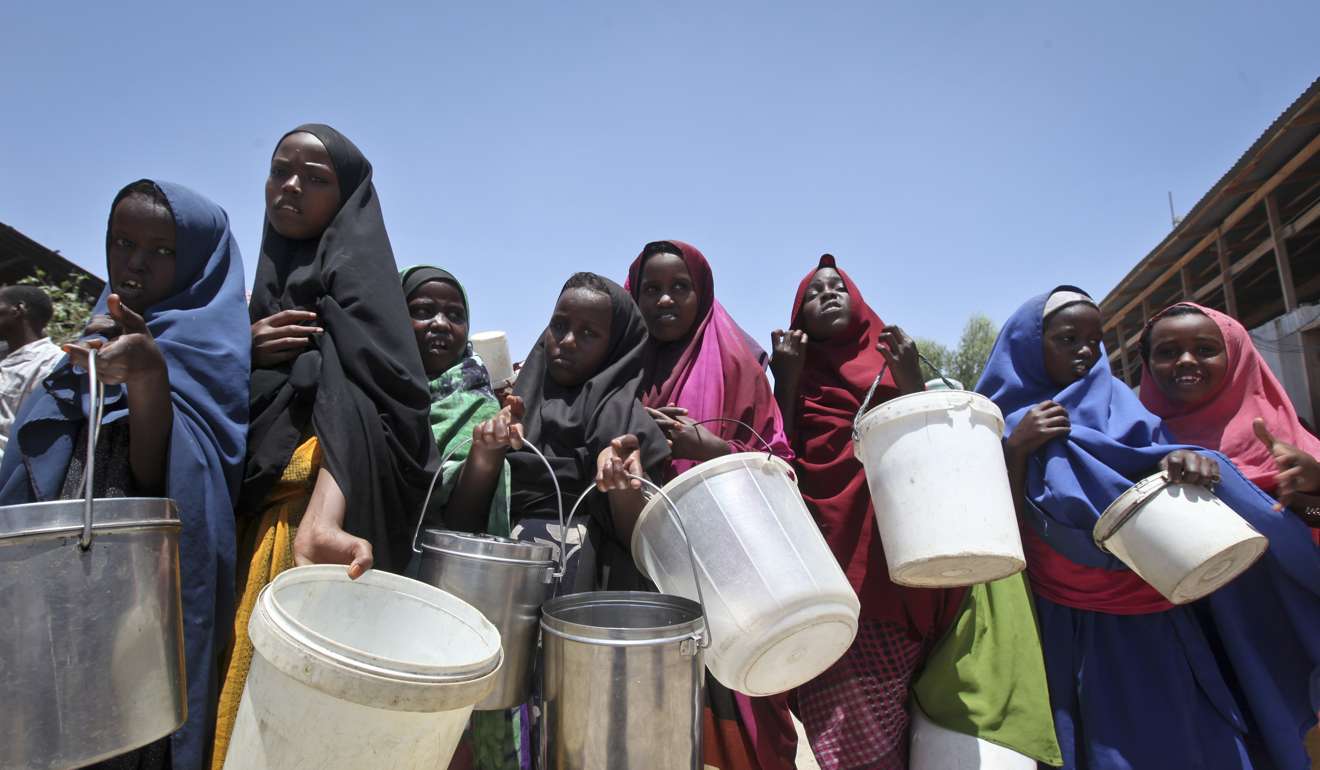 Displaced Somali girls who fled the drought stand in a queue to receive food handouts at a feeding centre in Mogadishu, Somalia. Photo: AP