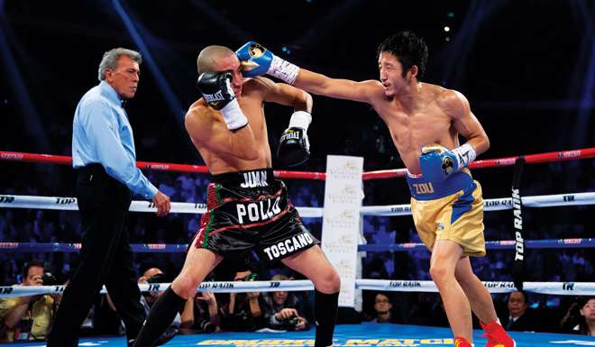 Zou Shiming strikes Mexican Juan Tozcano during his third professional fight in Macau in November 2013. Zou won the bout on points.