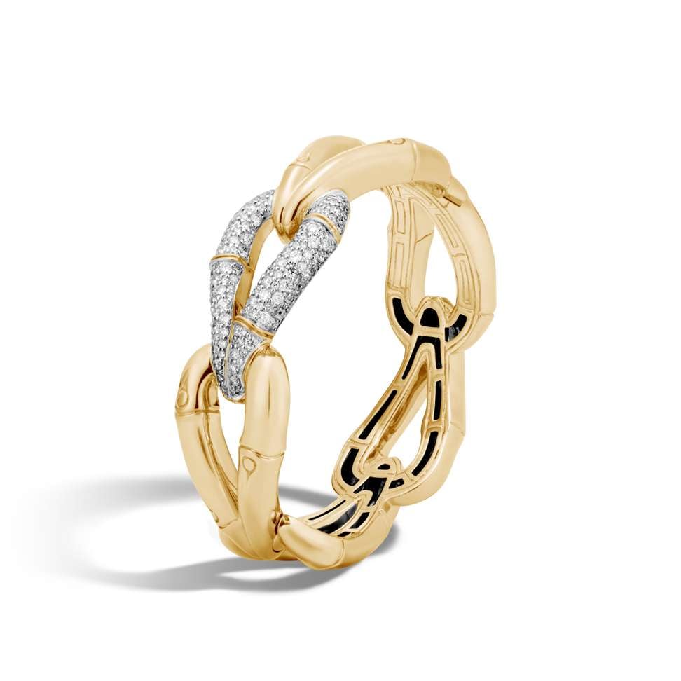 The 18ct gold and diamond pavé hinged bangle encircles the wrist in the shape of bamboo knots which symbolise strength and prosperity