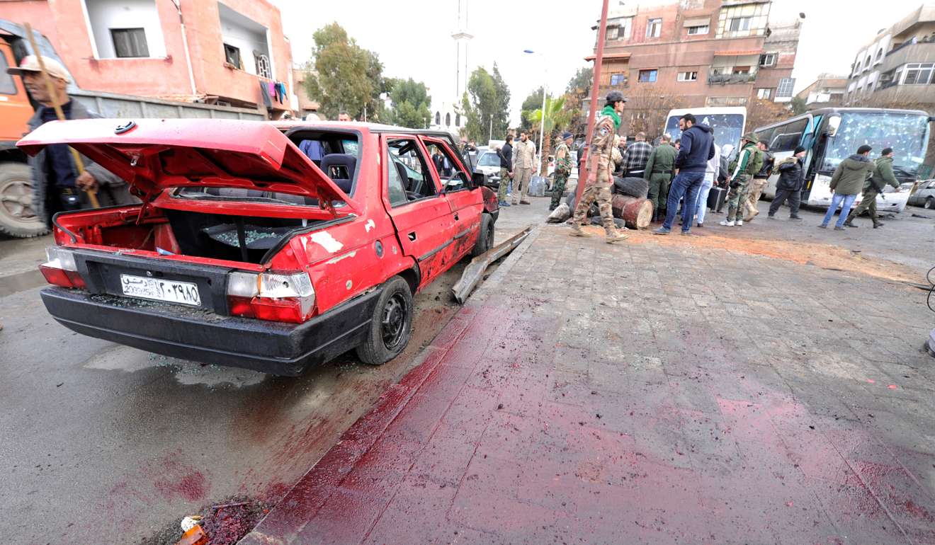 Blood stains the ground as people inspect the damage at the site of the attack. Photo: Reuters