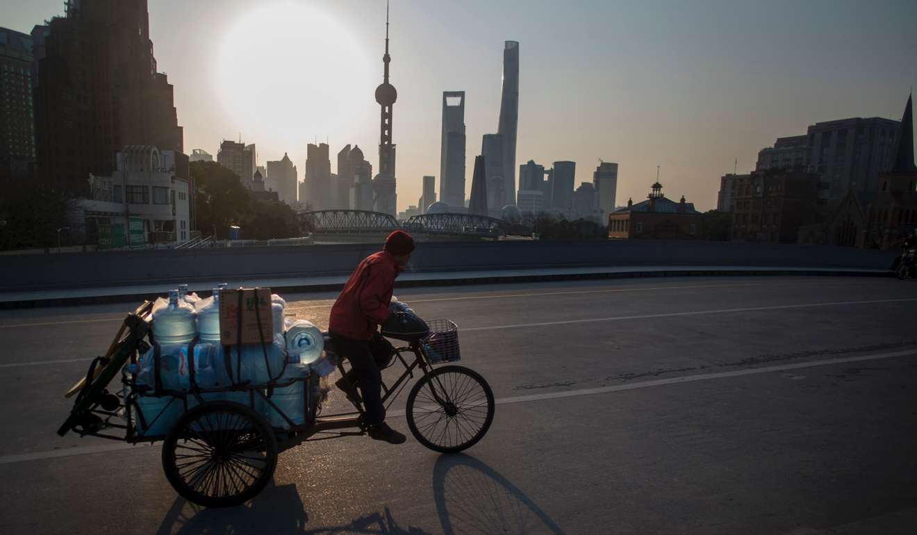 A water delivery man rides his tricycle over a bridge in Shanghai. With 70 per cent or more of the population living in urban areas, China could become a leading hub for clean technology innovation and the most experienced nation in environmental restoration. Photo: AFP