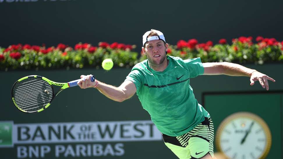 Jack Sock reaches for a forehand against Federer. Photo: AFP
