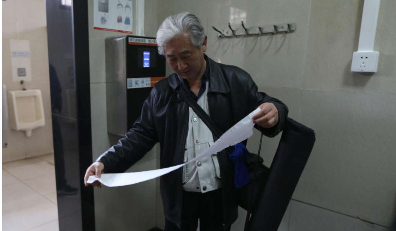 A visitor to the public toilet receives his 60cm ration. Photo: Handout