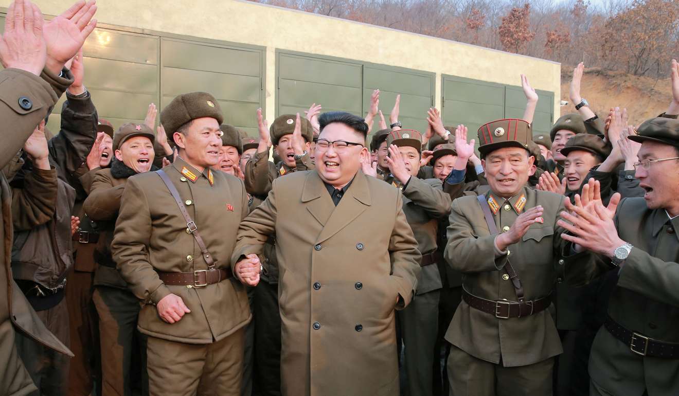 Kim Jong-un leads the celebrations after watching the test of a high-thrust rocket engine developed by North Korea, in a picture made available on March 19. Photo: KCNA/via Reuters