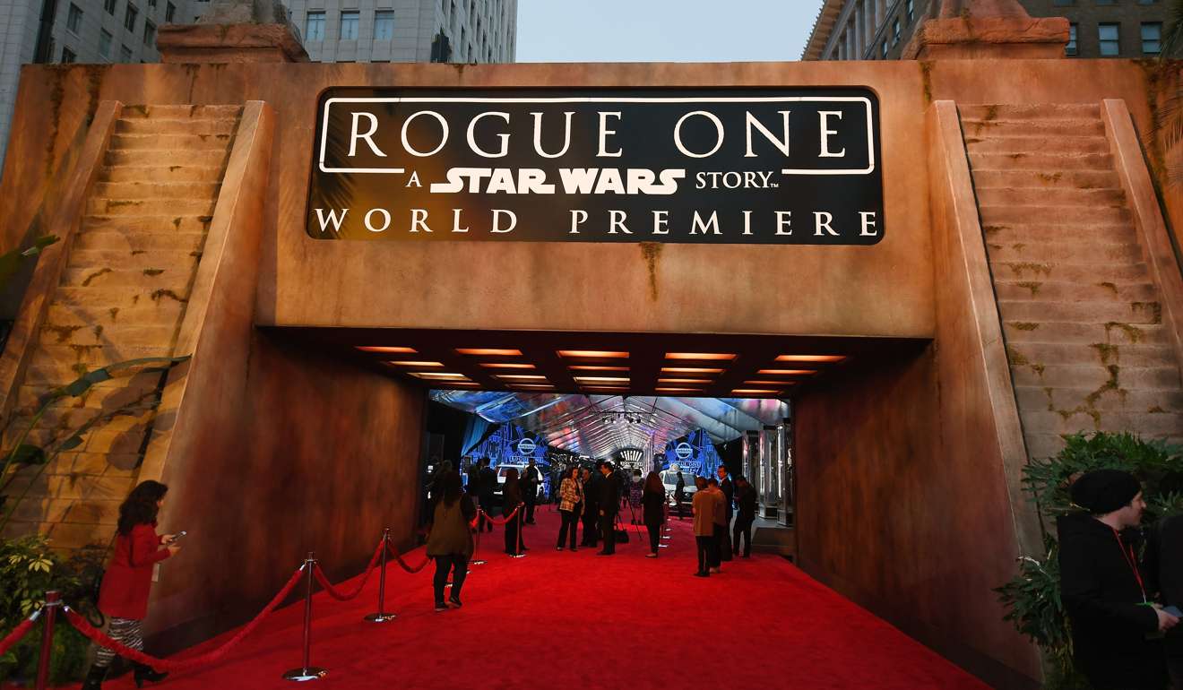 People walking near an entrance to the red carpet before the premiere of Walt Disney Pictures and Lucasfilm's 