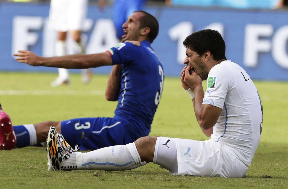 Uruguay striker Luis Suarez (right) was banned for fourth months for biting Italy defender Giorgio Chiellini. Photo: EPA