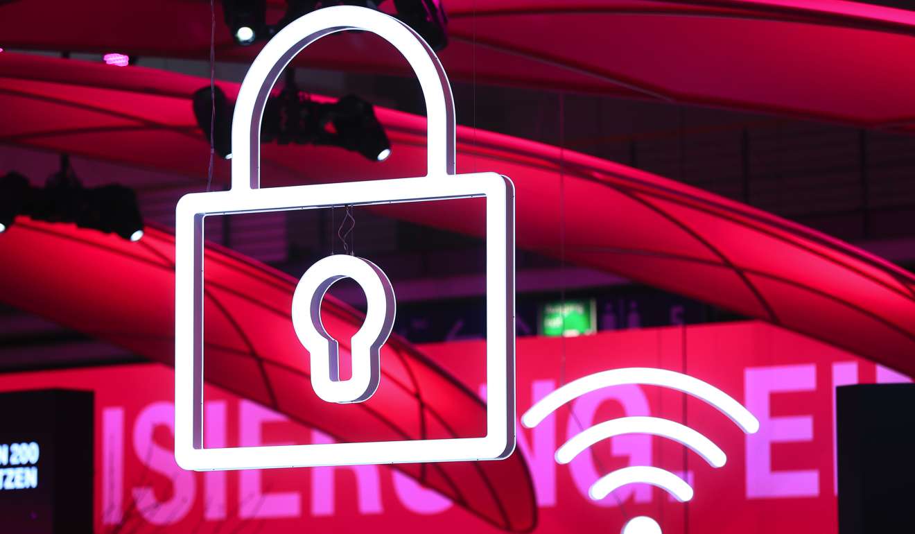 An iluminated icon representing cyber security at the CeBIT 2017 tech fair in Hannover, Germany. Photo: Bloomberg