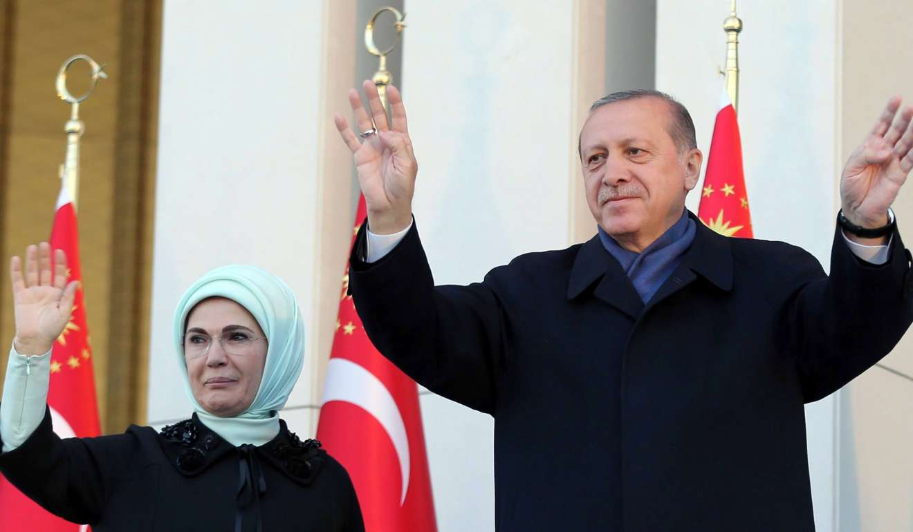 Recep Tayyip Erdogan and his wife Emine Erdogan acknowledge cheers from the crowd at the Presidential Palace in Ankara on April 17, following a narrow victory in a nationwide referendum that will give him sweeping new powers. Photo: AFP