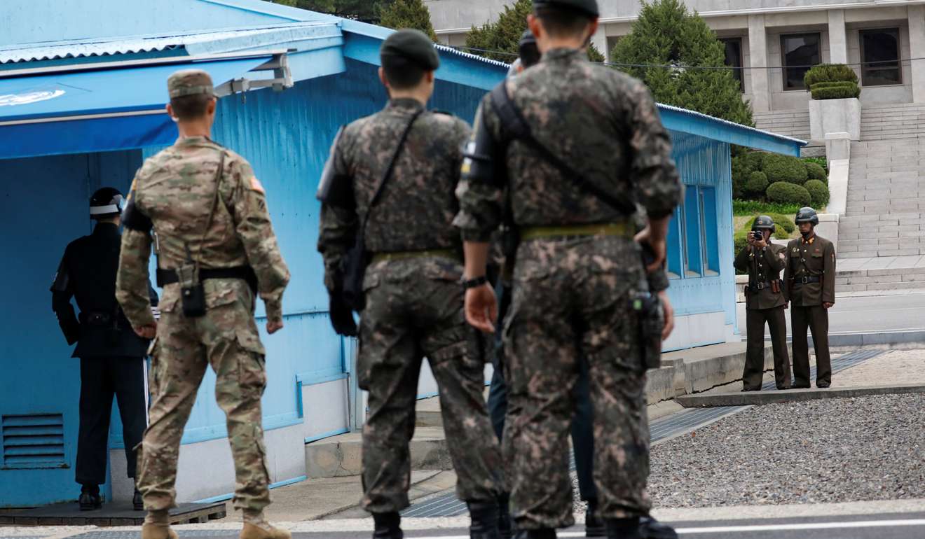 A North Korean soldier takes photographs as US Vice-President Mike Pence (not pictured) arrives at the truce village of Panmunjom, South Korea. Photo: Reuters