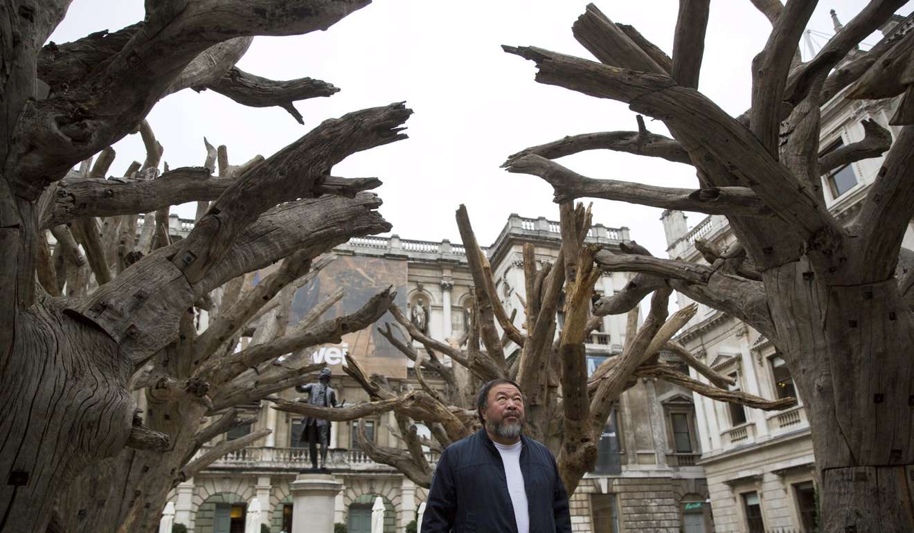 Ai Weiwei in front of his work ‘Tree’ during his exhibition at the Royal Academy of Arts in London. Photo: Reuters