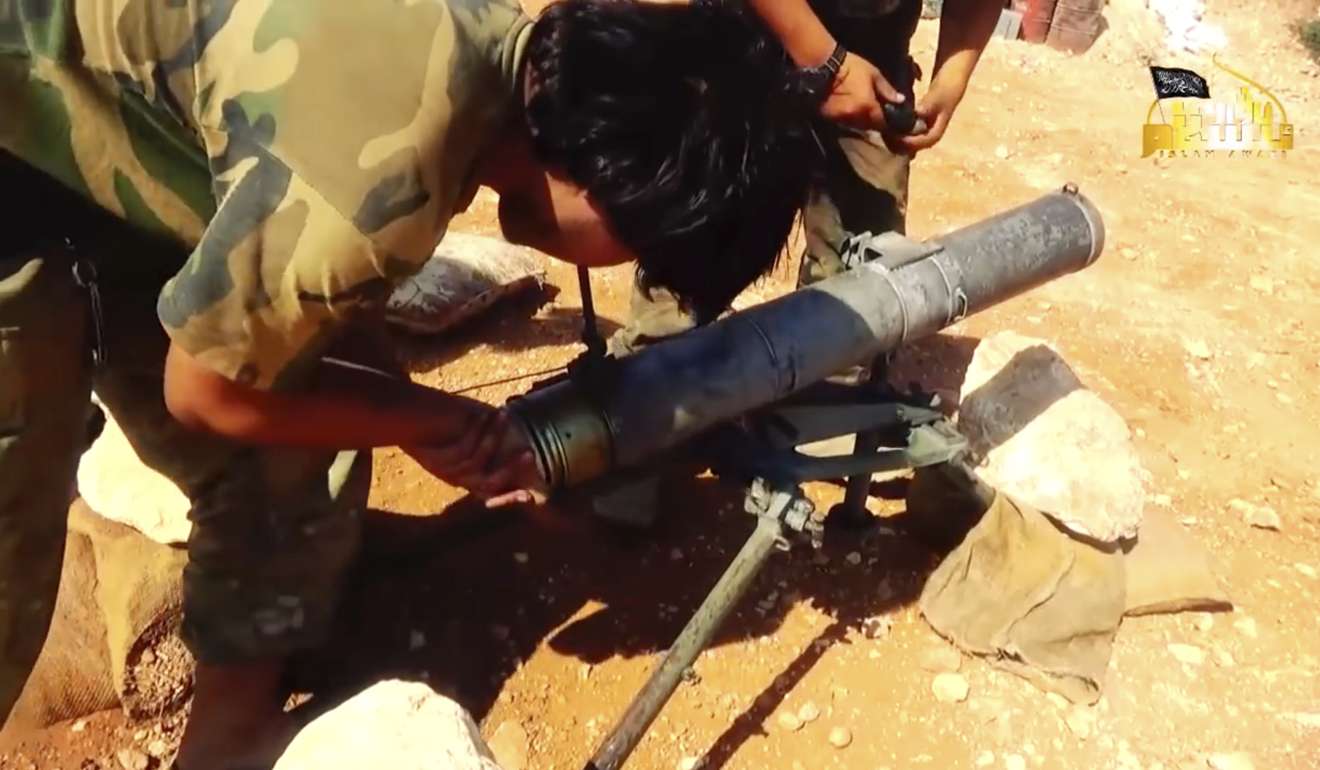 A screen grab from a video provided in August last year by the Turkistan Islamic Party showing what appears to be a Chinese militant preparing to fire a missile during a battle against Syrian government forces in Aleppo. Photo: Associated Press