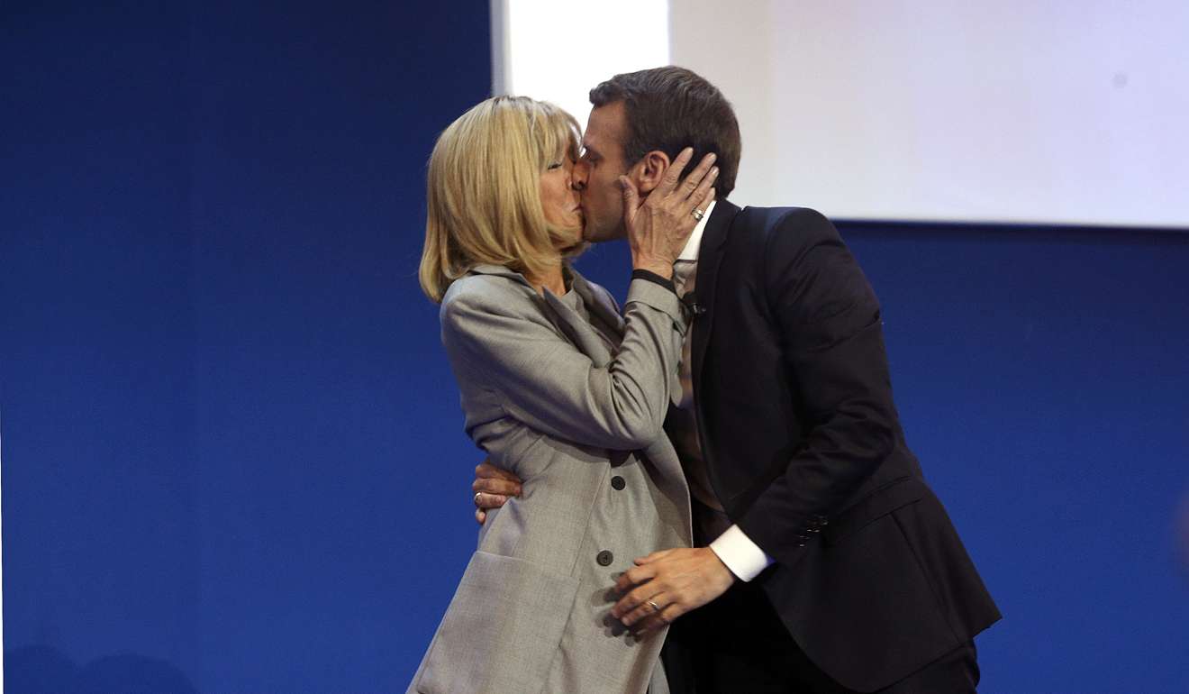 French centrist presidential candidate Emmanuel Macron kisses his wife Brigitte before addressing his supporters at his election day headquarters in Paris on Sunday. Photo: AP