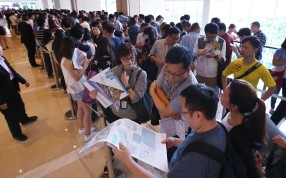 Queues formed at the sales office of China Overseas Land's One Kai Tak development in Hong Kong last month. Strong sales have boosted the company’s third-quarter profits. Photo: Felix Wong