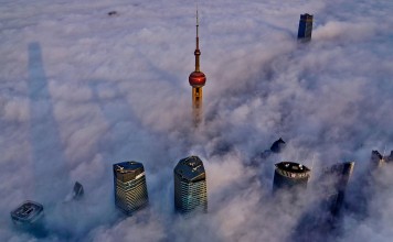 Tops of Shanghai's landmark skyscrapers, including the Oriental Pearl Tower, are seen over a sea of cloud. Opponents of tall buildings say Shanghai is like a 'monster city' because of the myriad of skyscrapers. Photo: Xinhua