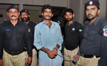 Pakistani police officers present Waseem Azeem, the brother of slain model Qandeel Baloch. Photo: AP