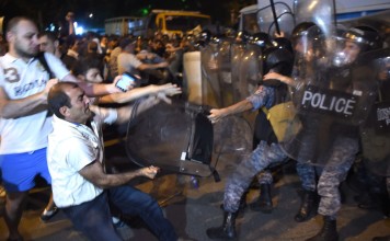 Protesters clash with police near a police station that was seized on 17 July in Yerevan, Armenia. Photo: EPA