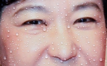 Rain drops are seen on a poster of Park Geun-hye. A corruption scandal has sent Park Geun-hye’s approval ratings diving to five per cent, a record low for a South Korean president. Photo: Reuters