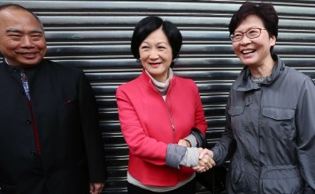 Regina Ip and Carrie Lam shake hands after running into each other following Lam’s meeting with Election Committee members from the agricultural and fisheries subsector in Aberdeen on January 30. Photo: Jonathan Wong