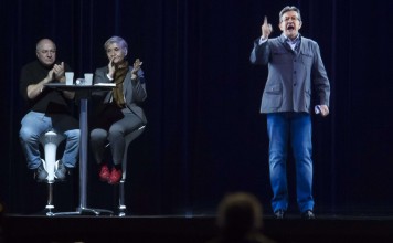 A hologram of far-left presidential candidate Jean-Luc Melenchon is displayed on stage as audience members look on, during a campaign rally in Saint-Denis, outside Paris, on Sunday. Melenchon gave the speech in person at a rally in Lyon. Photo: EPA