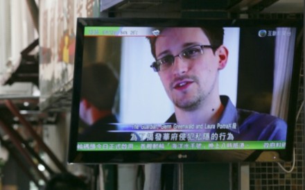 A TV screen shows the news of Edward Snowden at a restaurant in Hong Kong. Photo: AP A TV screen shows the news of Edward Snowden at a restaurant in Hong Kong. Photo: AP