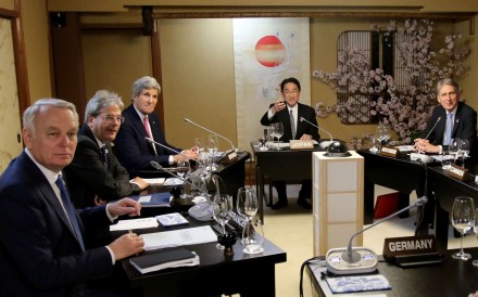 Japanese Foreign Minister Fumio Kishida (second from right) with French Foreign Minister Jean-Marc Ayrault (left), Italian Foreign Minister Paolo Gentiloni (second from left), US Secretary of State John Kerry (third from left) and Canadian Foreign Minister Stephane Dion (right) during their third session of the G7 Foreign Ministers' meeting in Miyajima on Sunday. Photo: AFP