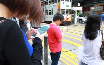Mobile phone use is ubiquitous on the streets of Hong Kong. Photo: SCMP