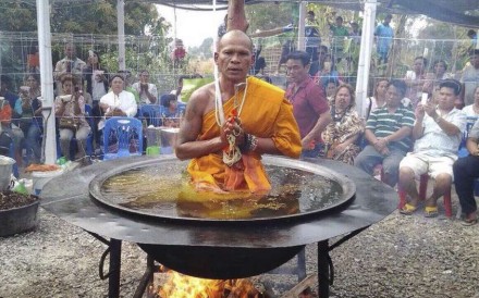 A monk sits in a vat of “boiling oil” in Thailand’s Nong Bua Lamphu province.