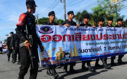 Thai soldiers march as part of a campaign encouraging the public to vote in the referendum on Thailand's draft constitution. Photo: AFP