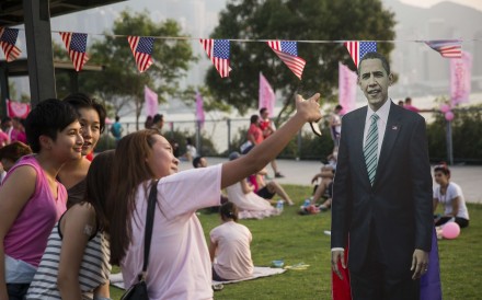 Friends take a selfie with a cardboard cut out of US president Barack Obama in Hong Kong. Photo: AFP