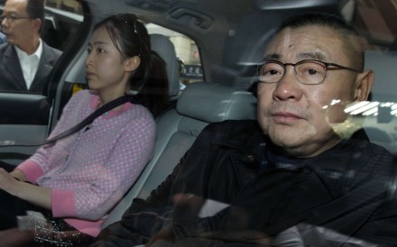 Joseph Lau leaves a Wan Chai restaurant with his girlfriend Chan Hoi-wan. Photo: Dickson Lee