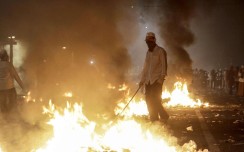 Flames rise as demonstrators clash with security forces during a protest against Governor Basuki ‘Ahok’ Tjahaja Purnama in front of the Presidential Palace in Jakarta. Photo: AFP