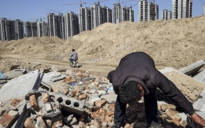 A 2013 image shows Li Rui scavenging for scrap metal where his village once was, in Liaocheng, Shandong province. Li was a farmer until six years ago, when the local government announced it would raze his village and turn farmland into an urban development zone. A 2013 image shows Li Rui scavenging for scrap metal where his village once was, in Liaocheng, Shandong province. Li was a farmer until six years ago, when the local government announced it would raze his village and turn farmland into an urban development zone.