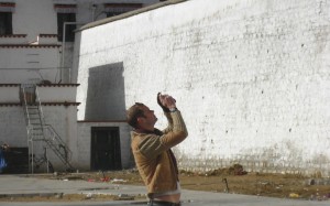 Should you engage? An unidentified Westerner takes a photograph in Tibet. Photo: Cecilie Gamst Berg
