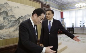 China's Premier Li Keqiang (right) shows the way to Japanese Foreign Minister Fumio Kishida during a meeting at the Zhongnanhai leadership compound in Beijing on Saturday. Photo: AP