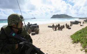 A soldier with the Japan Maritime Self-Defence Force sets up a perimeter defence during a simulated beach assault at Marine Corps Base Hawaii. Photo: Reuters