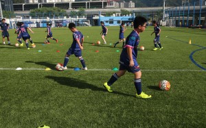 Children play football at Jockey Club Kitchee Centre in Shek Mun. Photo: David Wong