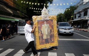 A man carrying a portrait of King Bhumibol Adulyadej. Photo: Reuters