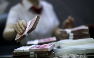 A file picture of a bank worker counting cash at a branch in Shanghai. Photo: Reuters