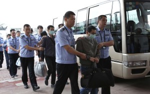 Chinese fugitives involved in economic crimes are returned to Beijing under escort from Indonesia under China’s Operation Fox Hunt. Photo: Xinhua