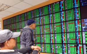 Negative economic consequences of a A Trump administration will likely have a negative impact upon Asia, with export-reliant China and Hong Kong particulary at risk. Investors monitor stock price movements in Taipei on November 9, 2016. Photo: EPA