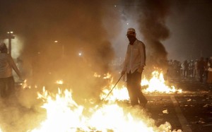 Flames rise as demonstrators clash with security forces during a protest against Governor Basuki ‘Ahok’ Tjahaja Purnama in front of the Presidential Palace in Jakarta. Photo: AFP