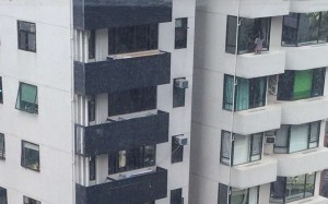 A domestic helper recently photographed cleaning the windows of a 15th-floor apartment in the Silvercrest building, MacDonnell Road, Mid-Levels. Photo: SCMP Pictures