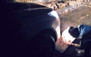 The stranded driver uses a conventional road map after his phone’s GPS route left his car stuck in a muddy ditch. Photo: SCMP Pictures The stranded driver uses a conventional road map after his phone’s GPS route left his car stuck in a muddy ditch. Photo: SCMP Pictures