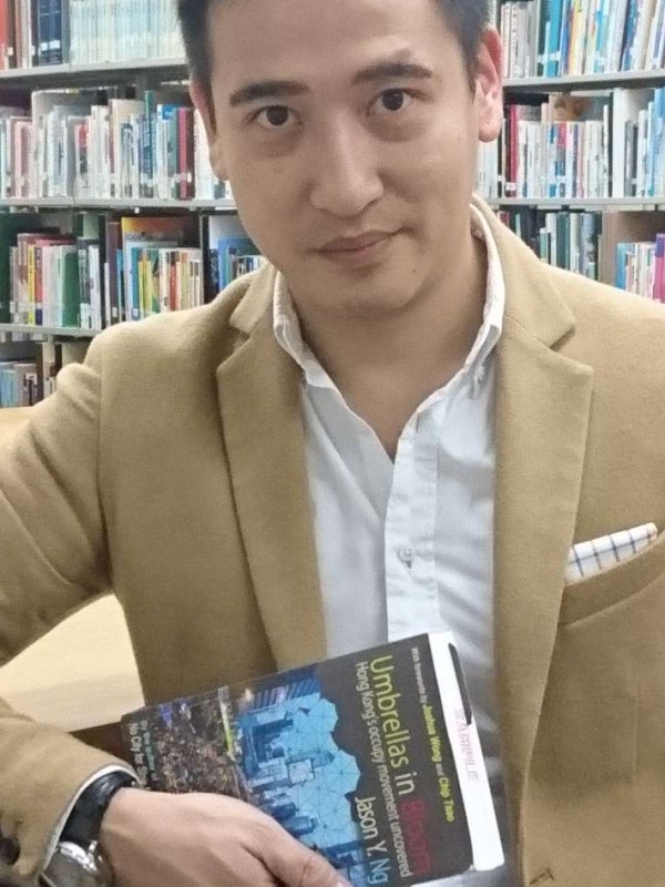 Jason Ng with a copy of his new book, Umbrellas in Bloom. Photo: Elaine Yau